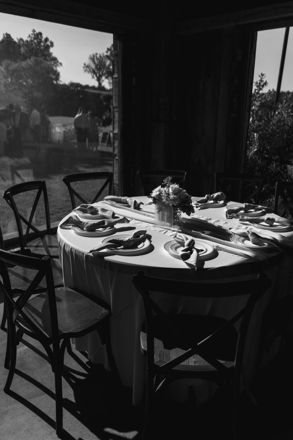 Elegant table settings in silhouette against a window in black and white.
