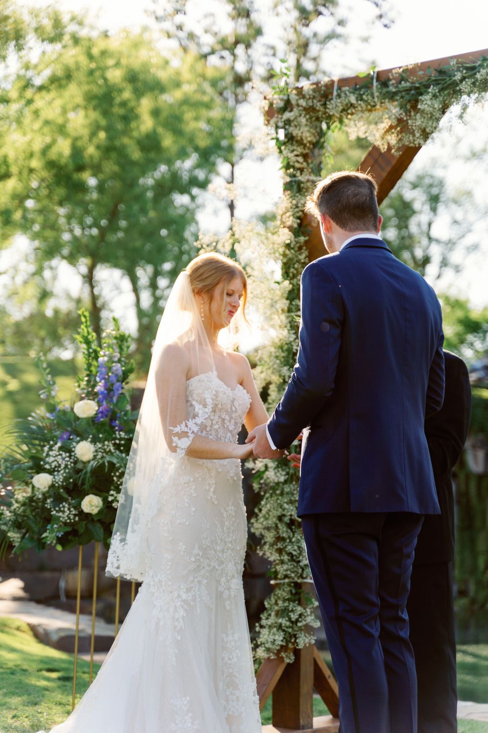 Wedding ceremony setup with floral arrangements and elegant decor outdoors.