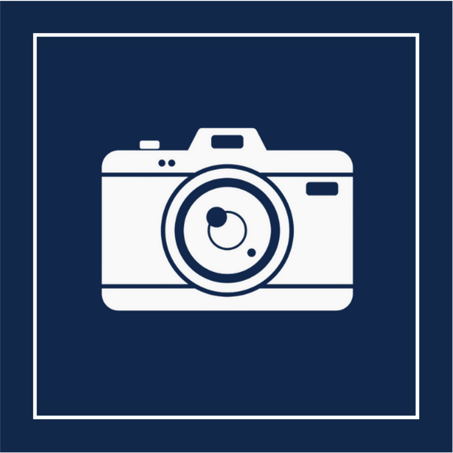 A white camera icon on a navy background with a white border, showcasing Studio 22's multifamily real estate photography services.