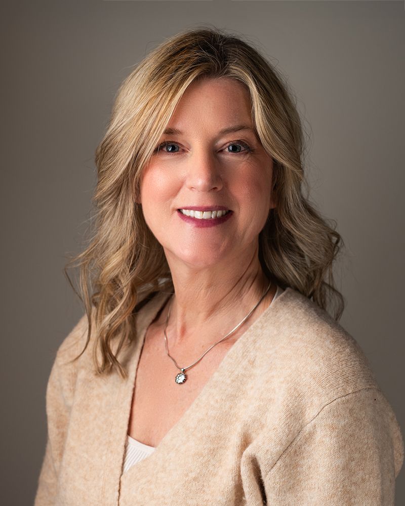 Headshot of Tania Veitch with hair down wearing a cream coloured sweater.