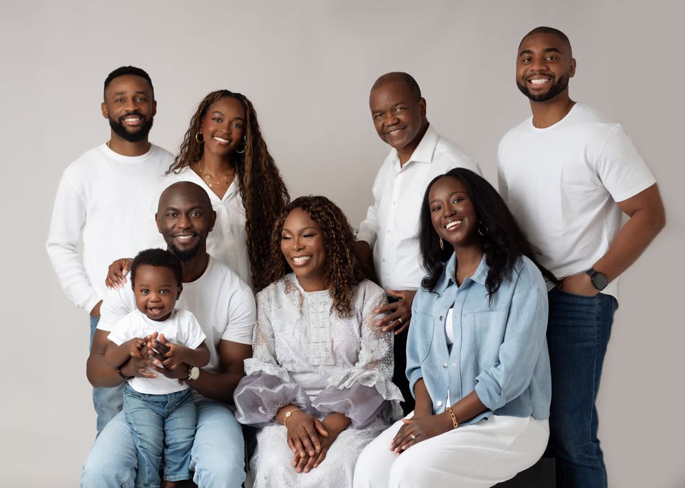 A series of professional family portraits showing joyful moments in coordinated white and light blue outfits against a neutral backdrop.