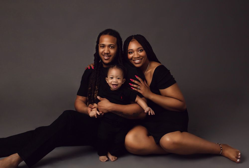 A black and white photo collage shows a family in matching outfits posing together in various intimate portraits.