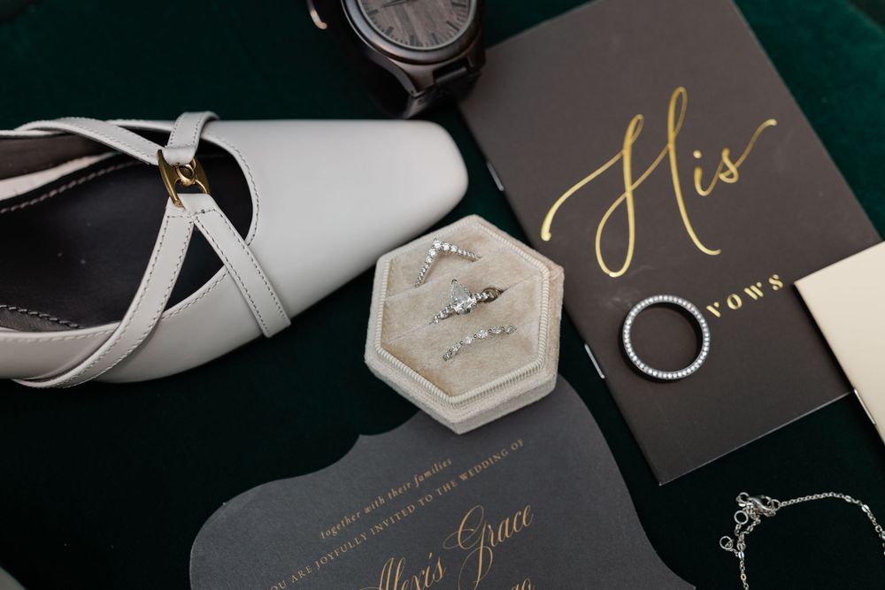 Elegant black and gold wedding stationery and invitations on dark background.