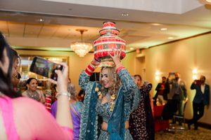 People in a banquet hall celebrating with colorful Christmas hats and festive decorations during a holiday party.