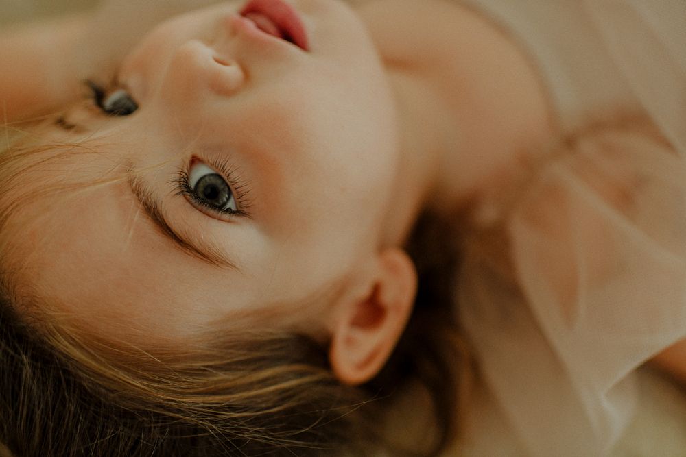 Artistic close-up portrait of a baby's face with soft natural lighting.
