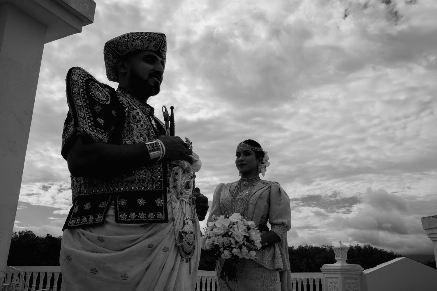 Black and white panoramic series showing couple's silhouettes against cloudy sky backdrop.
