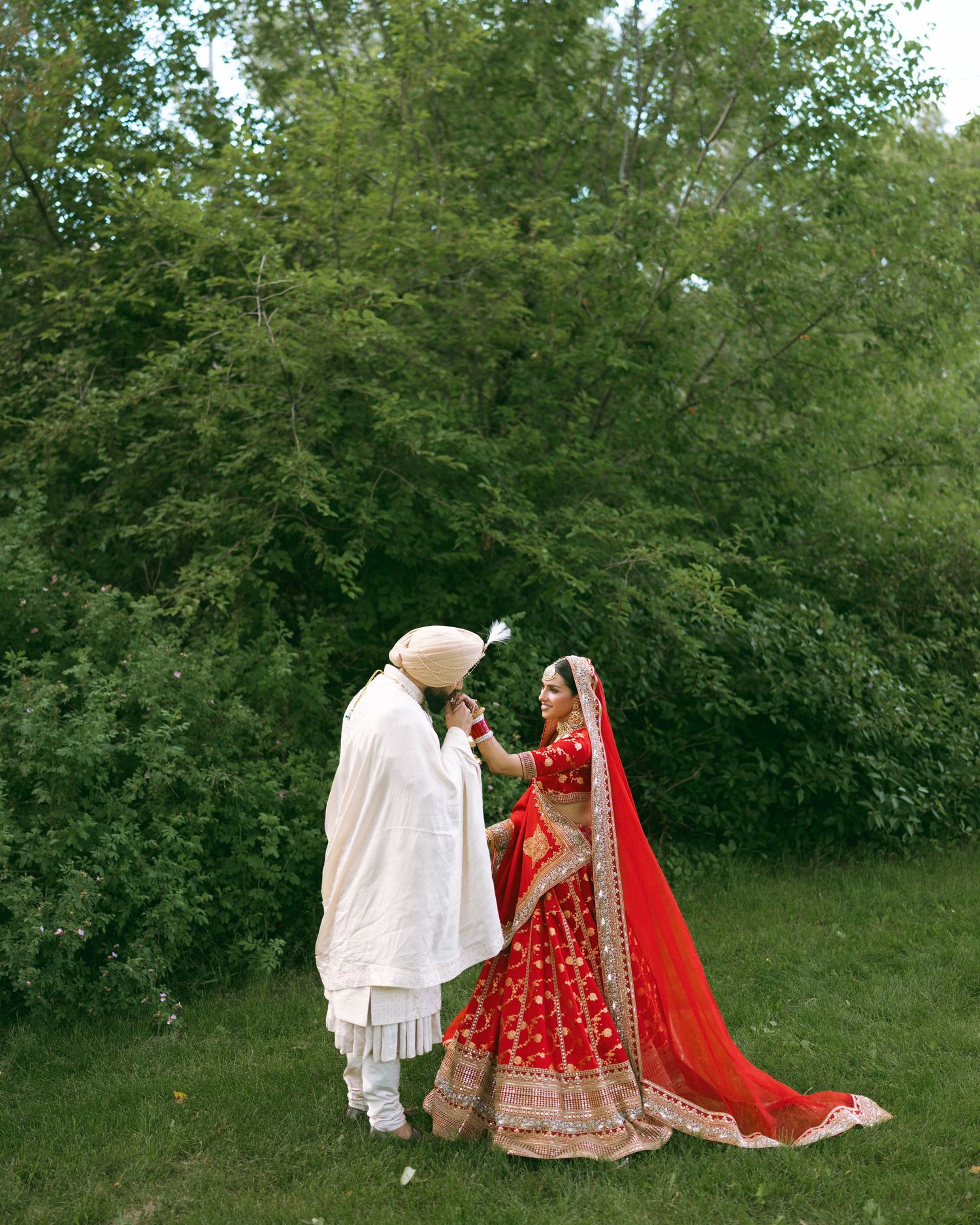 Beautiful traditional formal wear displayed in rich warm tones against vintage furniture and bird artwork.