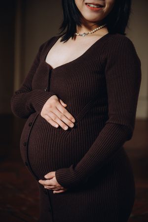 A series of maternity photos showing a person in a brown ribbed sweater cradling their pregnant belly.