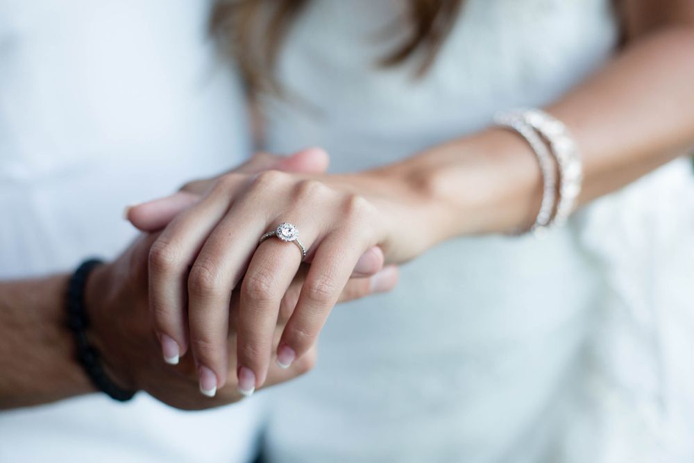 engagement couple holding hands and showing off their engagement ring during melbourne photoshoot