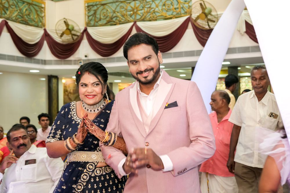 Festive celebration moment in decorated indoor venue with pink and white theme.