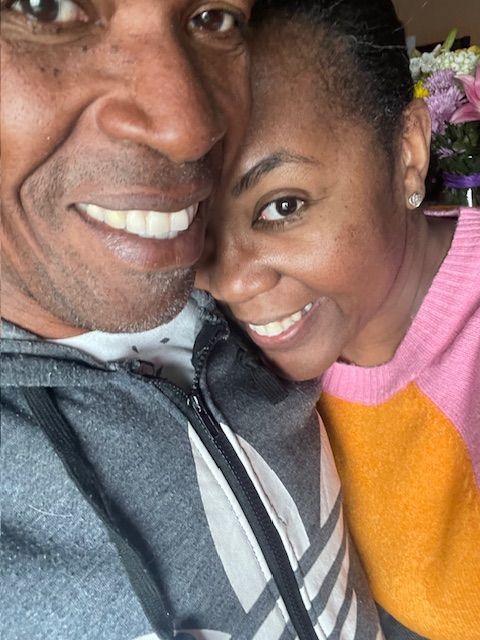 A close-up selfie of a happy couple sharing an intimate moment together.
