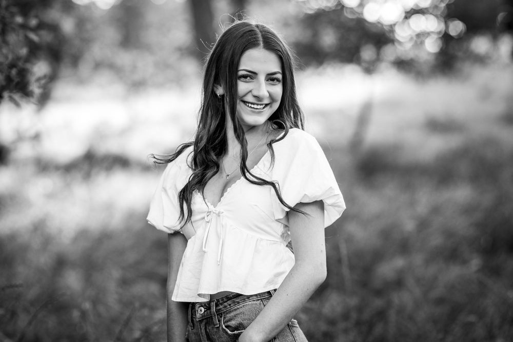 A series of black and white portraits showing a person in casual attire posing outdoors with natural lighting.