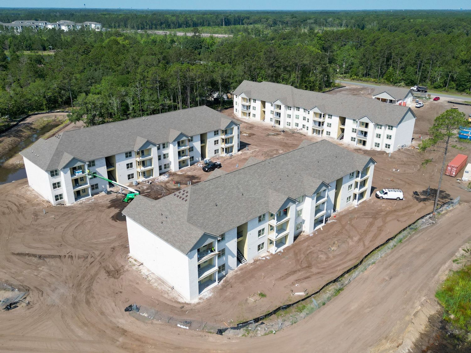 Aerial photograph of multi-unit residential buildings during construction phase.