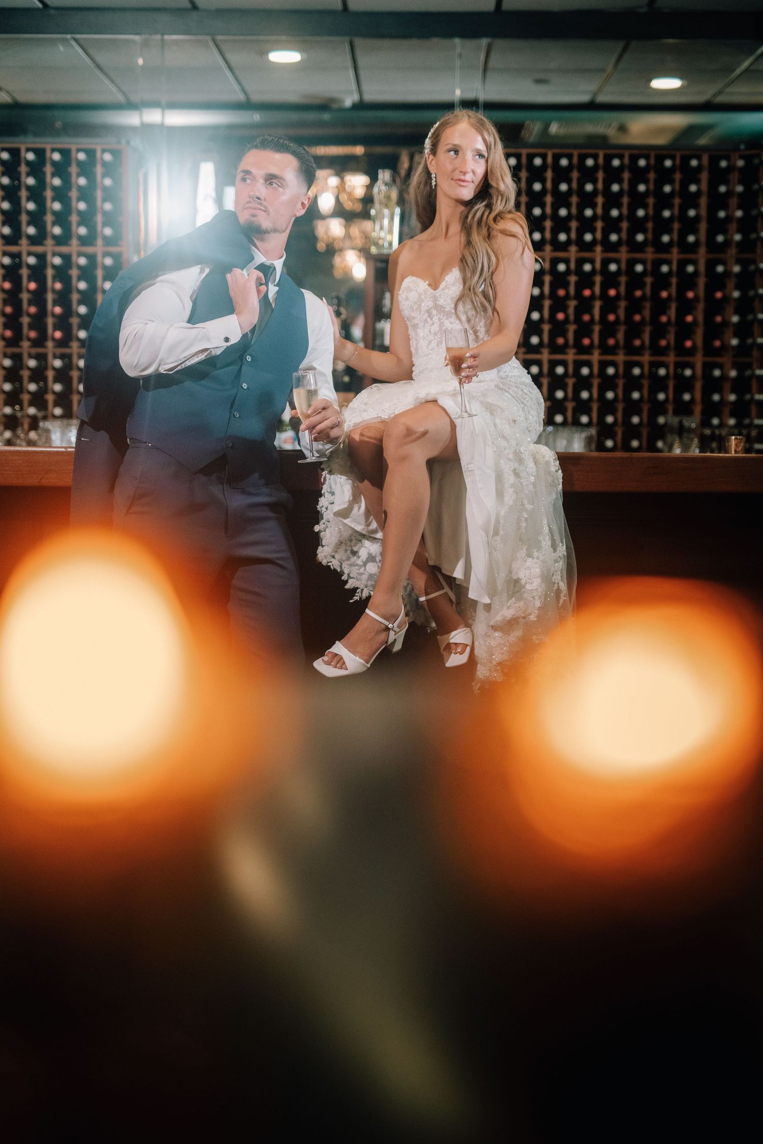 Bride and groom portrait at the bar at Flowerfield in St. James, New York, with warm lighting.