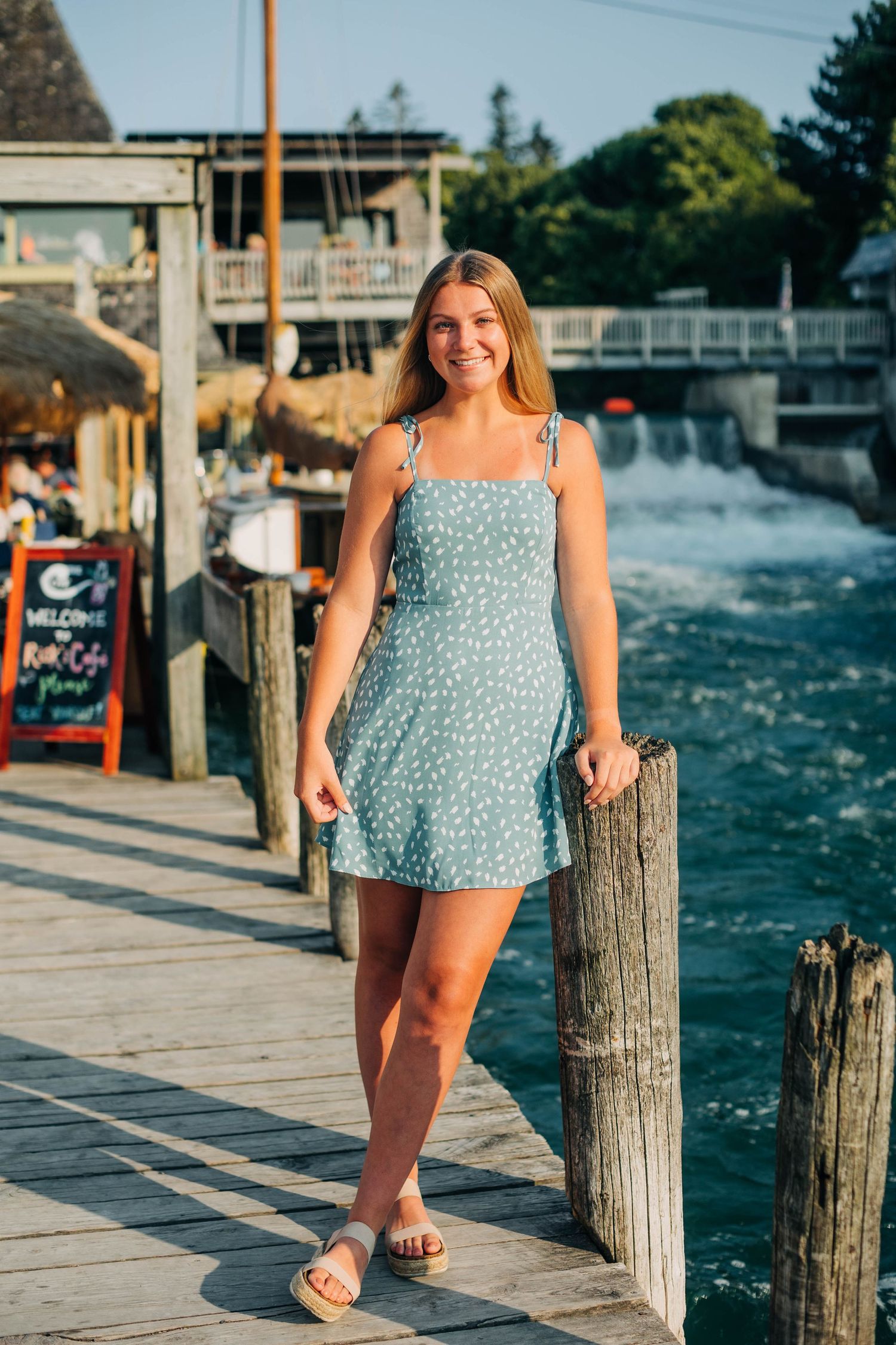 High School Senior Portrait on the docks of the River at Fishtown in Leland, Michigan Captured By Grace Hudson Photograp