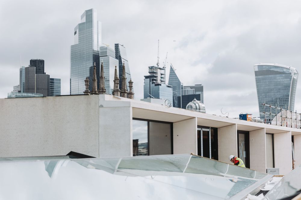 Modern urban skyline view through construction site windows.