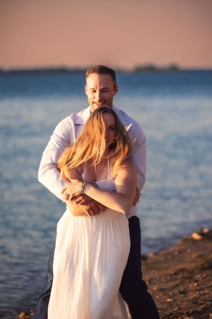 A romantic beach photo session at sunset with gentle embraces.