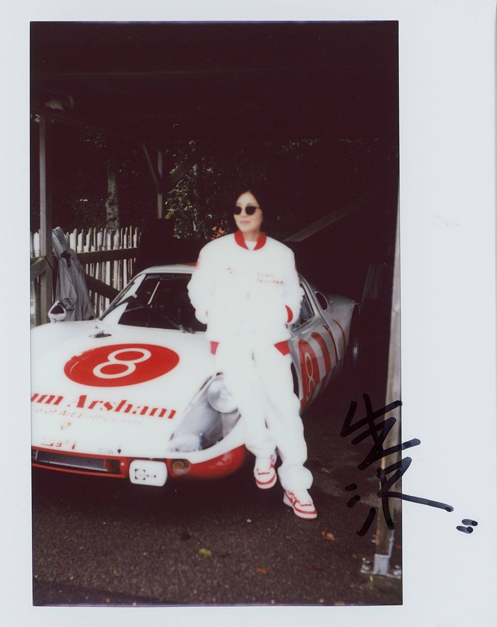 A portrait of Mai Izukawa with her father's race car. Featuring Team Izukawa at Goodwood Revival.