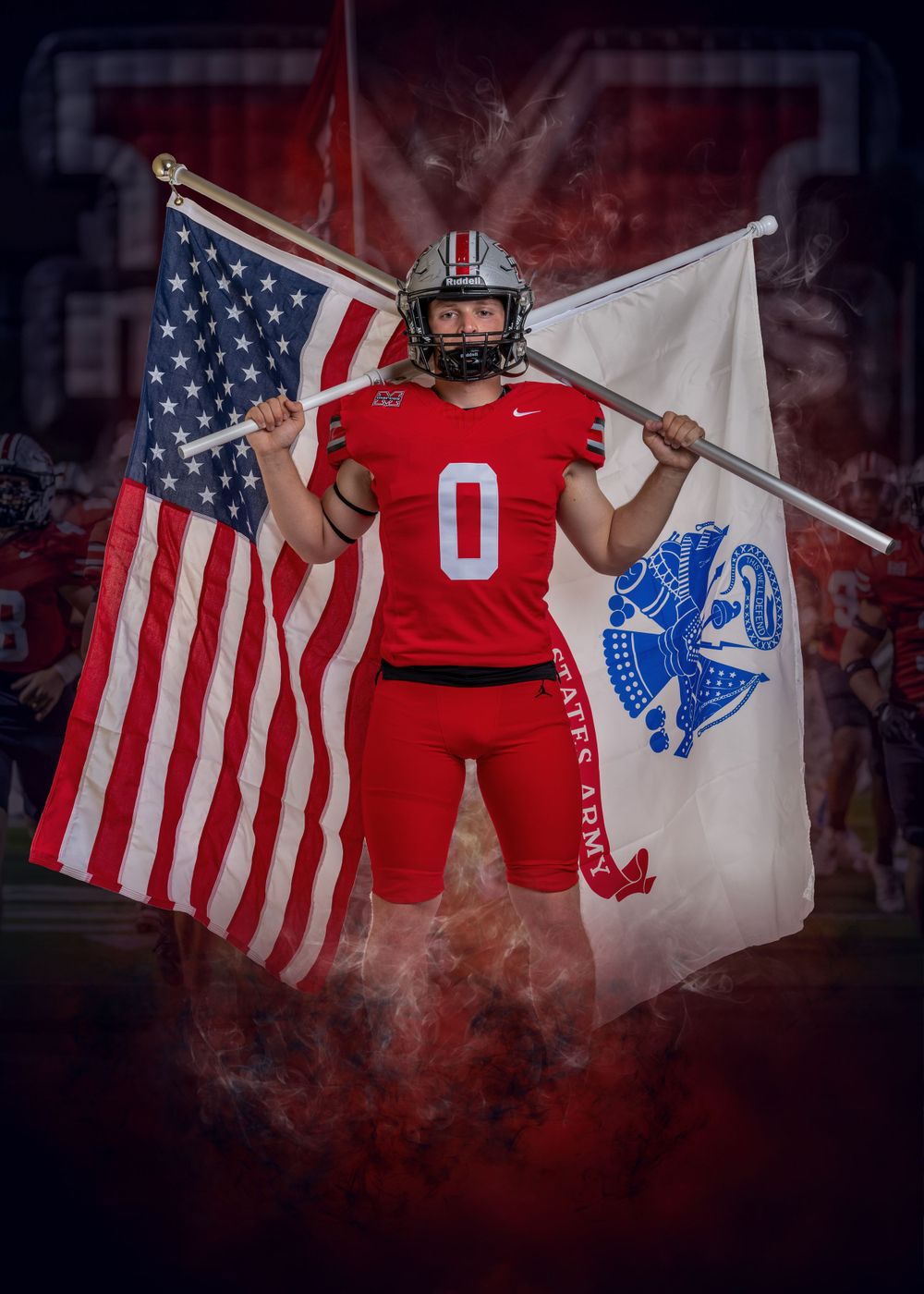 Football player in red jersey number 0 poses with American flag and St Michael flag against dramatic smoky background.