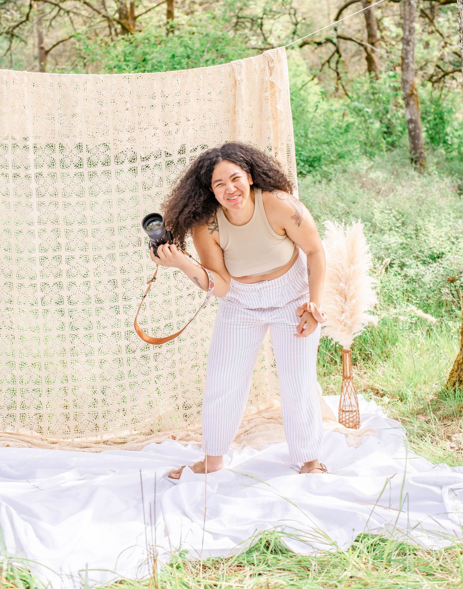 Dreamy summer photoshoot with white decor and vintage lanterns in a garden setting.