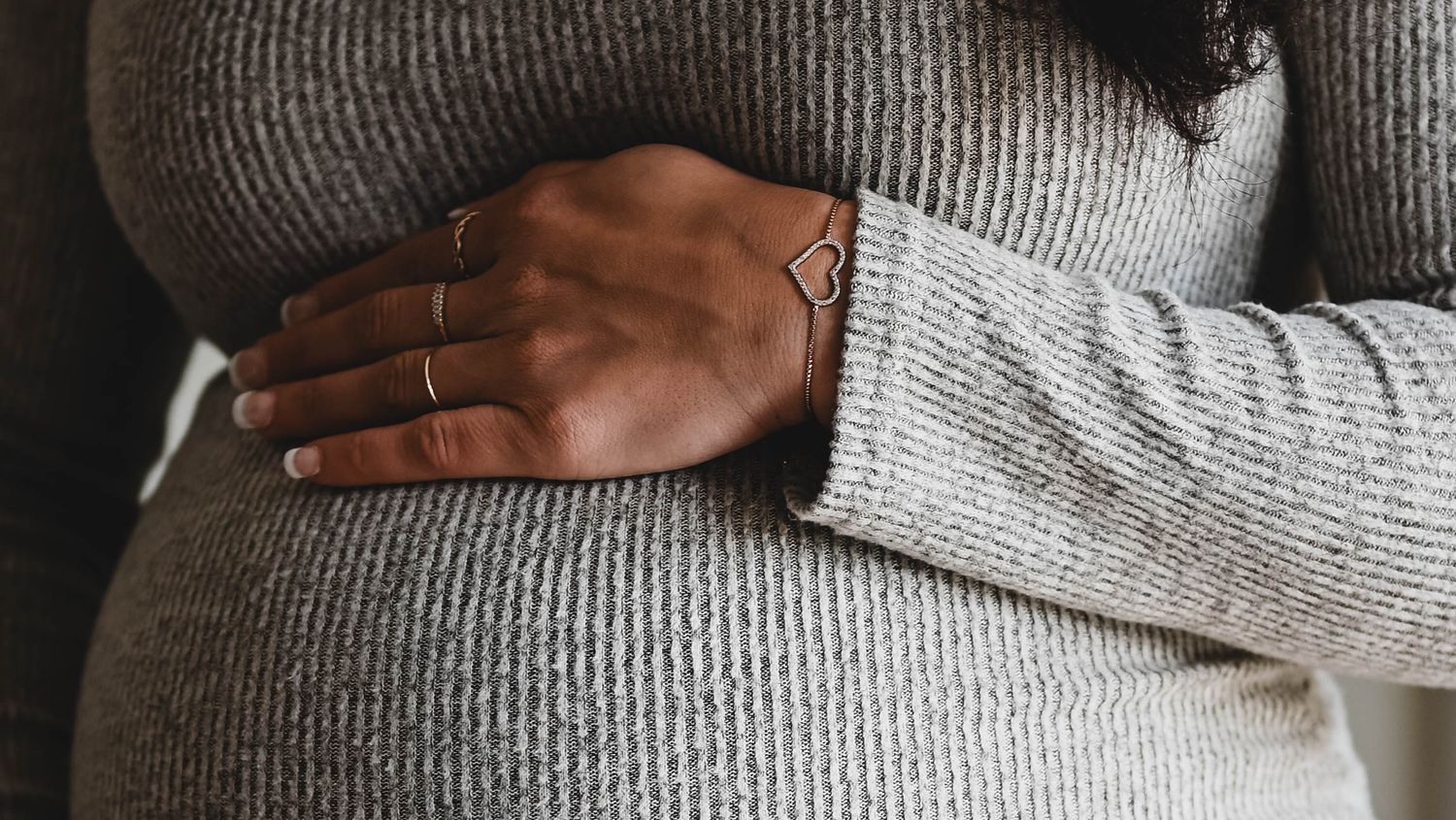 Mom's hands rest on her pregnant belly in this maternity session with K. Manchuck Photography in Albany, NY