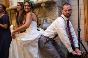 The bride and groom strike a fun pose during their wedding reception.