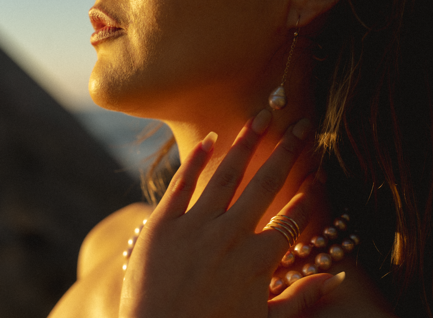 women posing on a beach in Kauai with pearls on