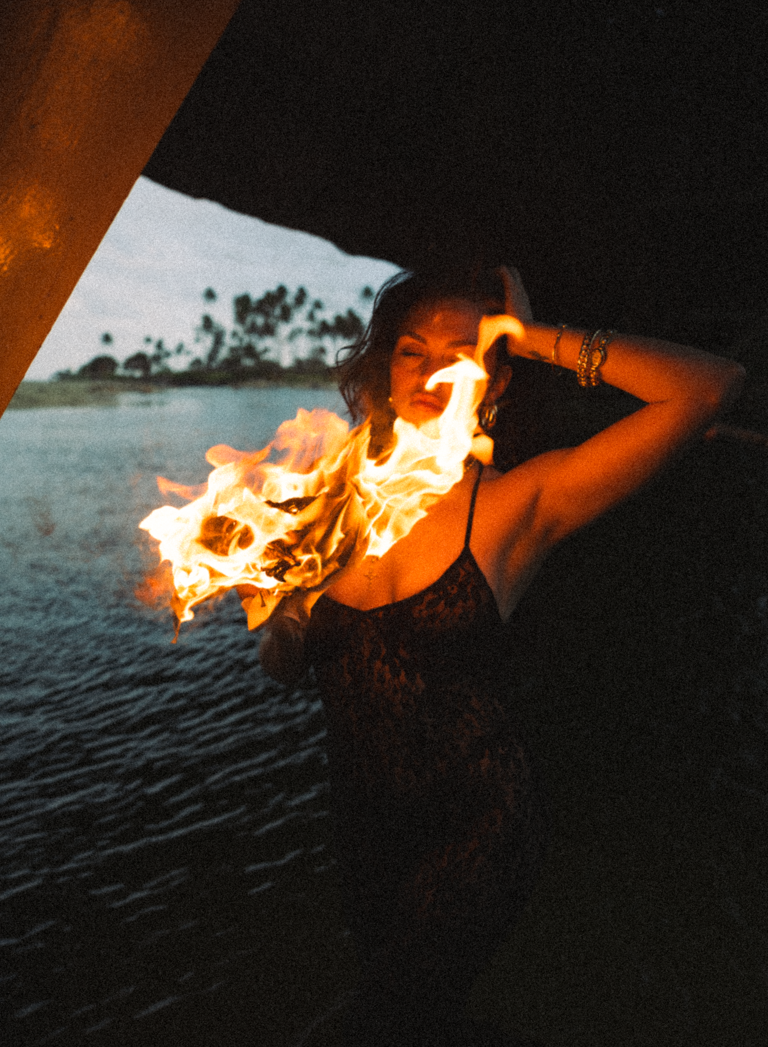 girl reading the newspaper in Hawaii with fire buring kauai