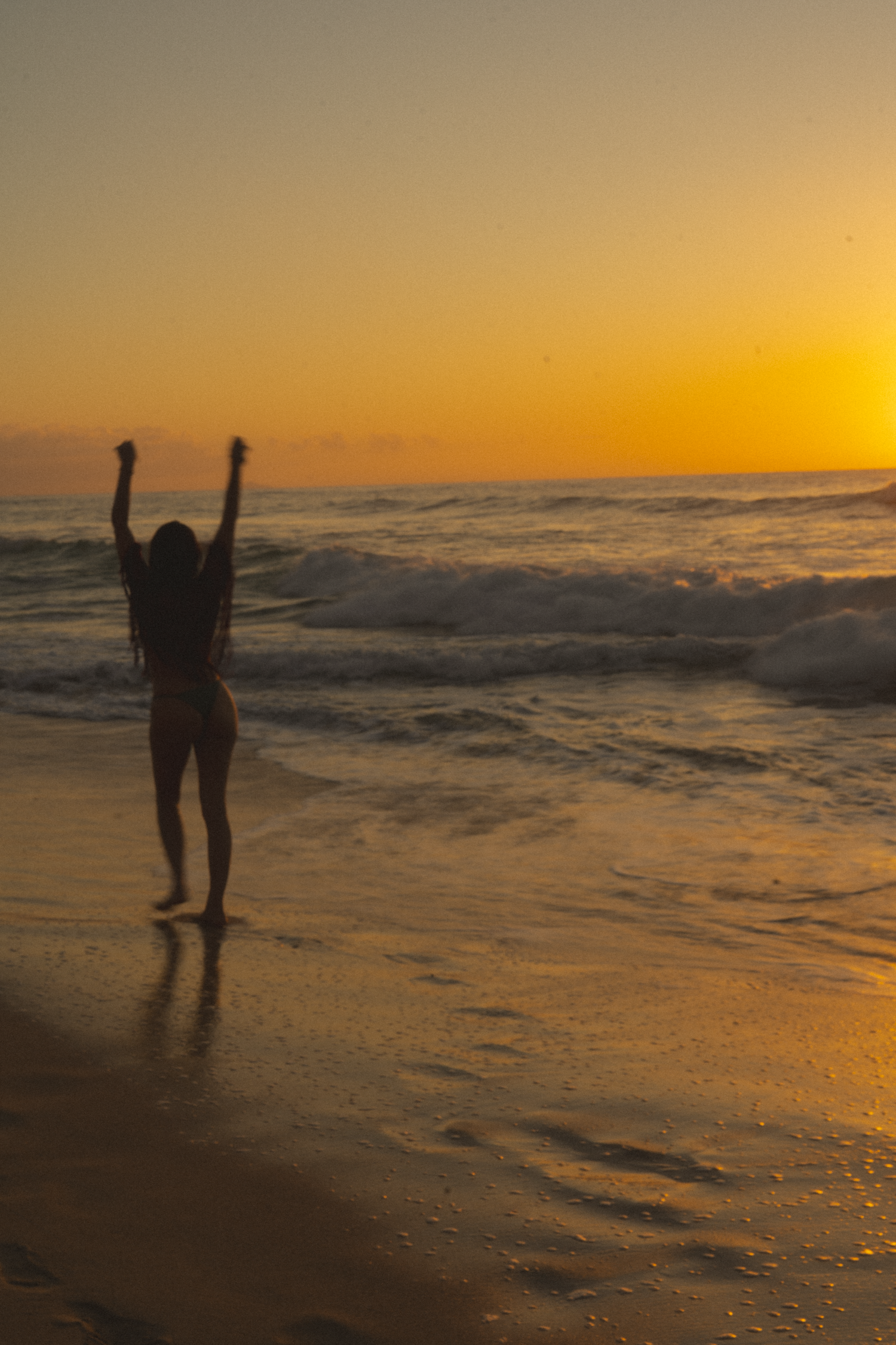 walking the Long Beach of Polihale Kauai, during the sunset hour of golden lighting