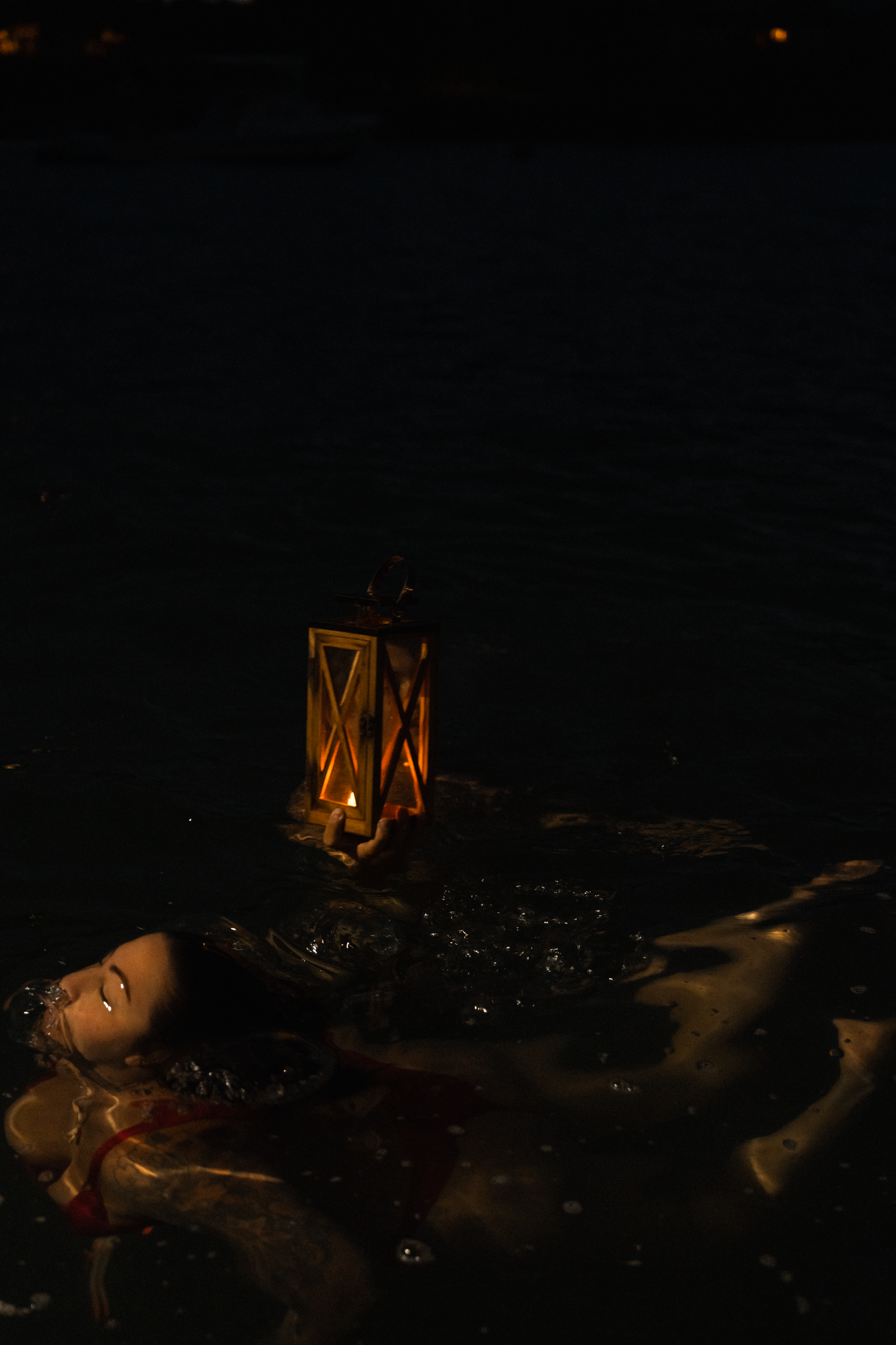 Moody candlelit scene with soft shadows and glowing lanterns creating atmospheric lighting effects.