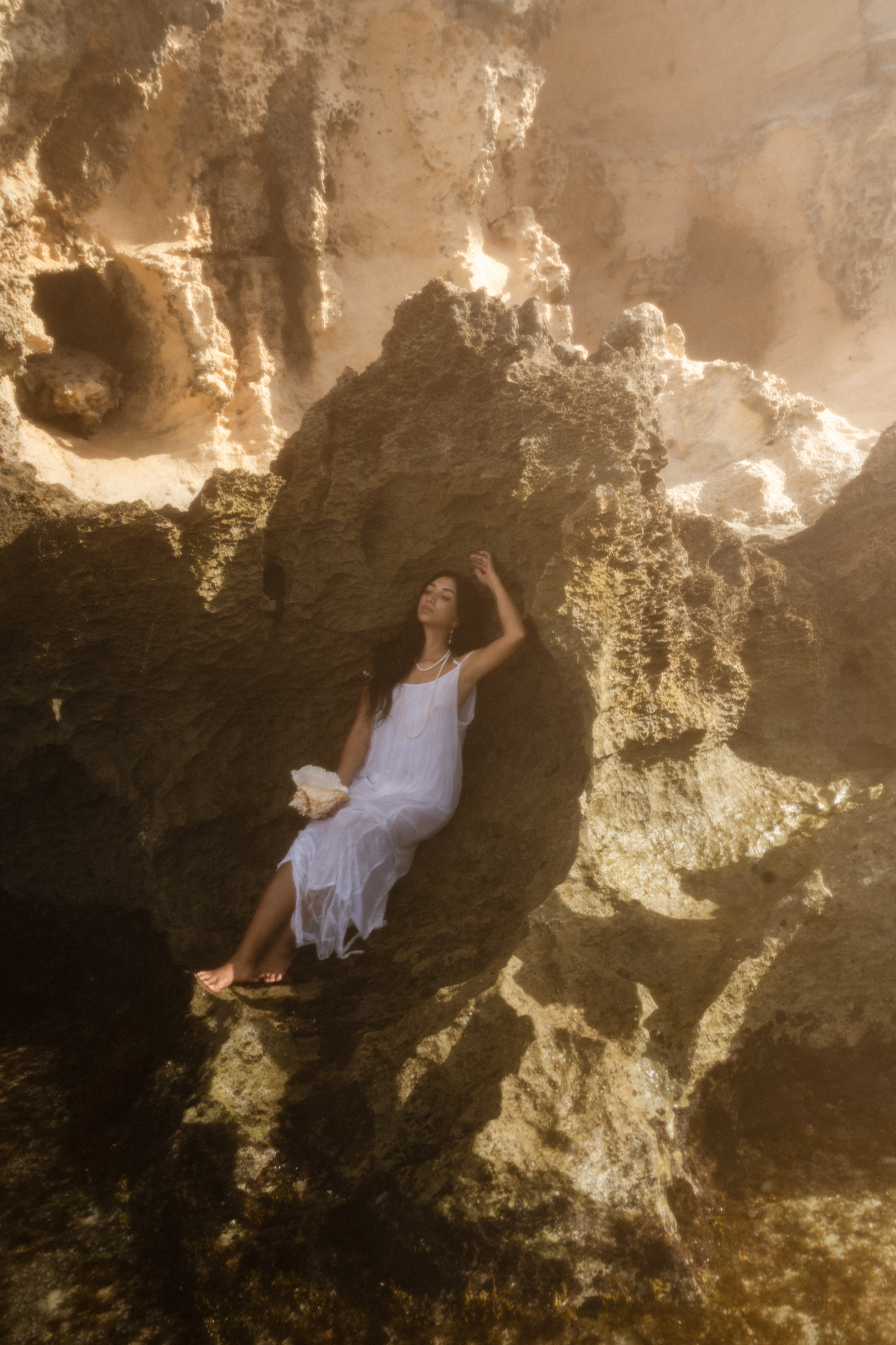 girl as a mermaid in the wet waves of kauai