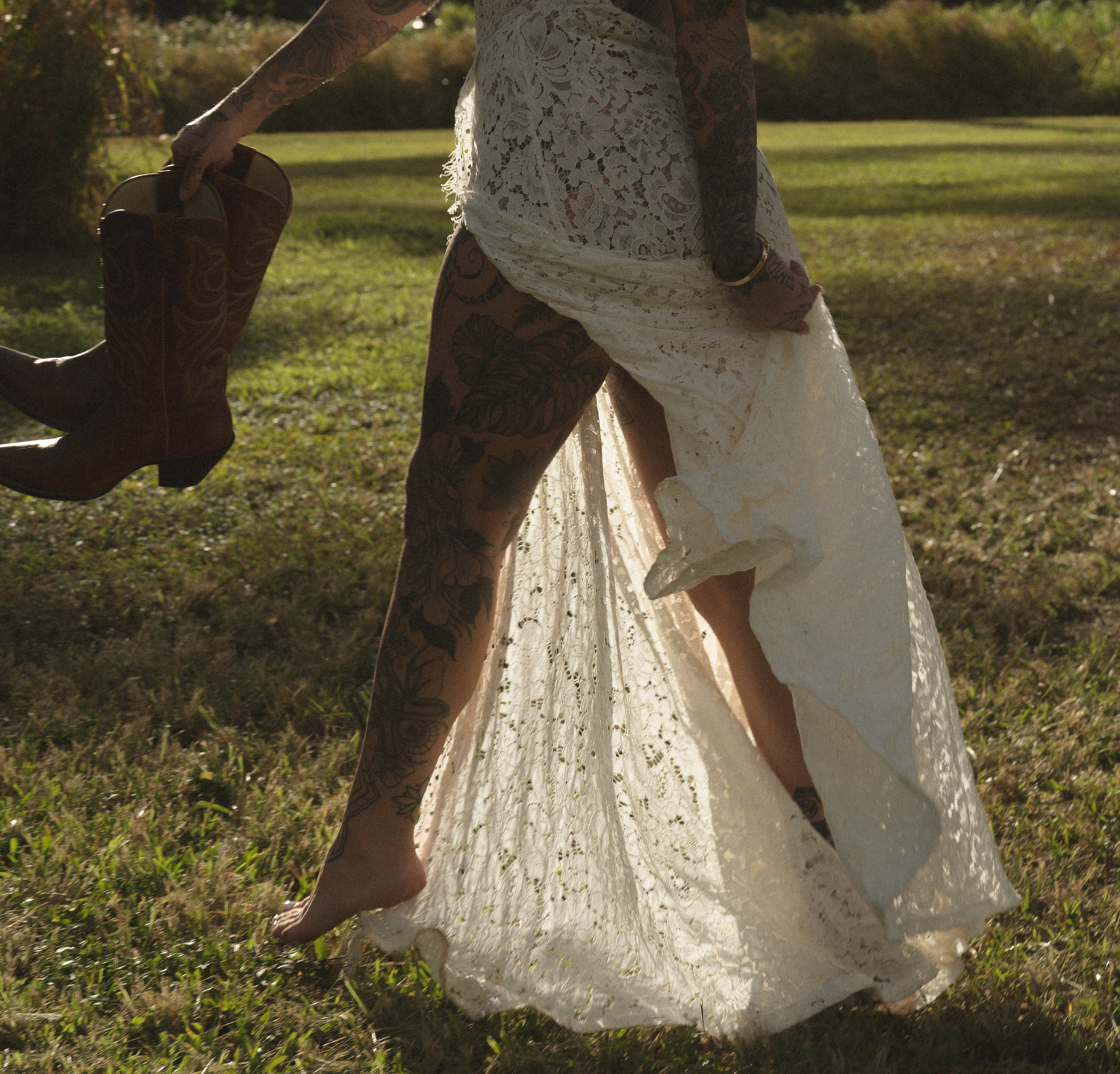 Person in white lace dress twirling in a sunlit meadow.