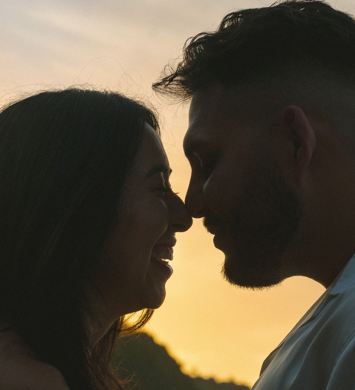Silhouetted couple in profile against golden sunset, shown in progressive frames moving closer together.