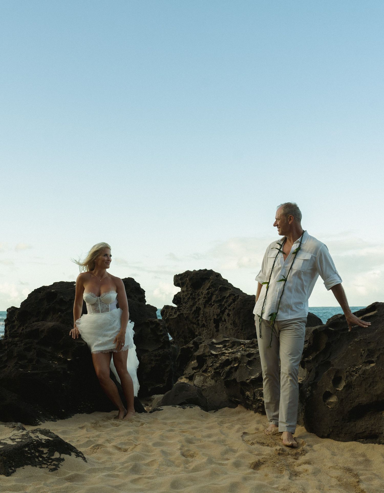 A sequence of five photos shows people exploring rocky coastal formations on a sandy beach at sunset.