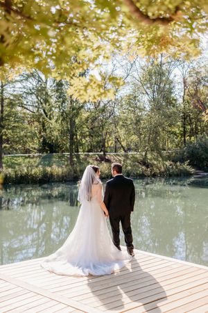 Portrait of bride and groom in a park overlooking a lake in Cincinnati.