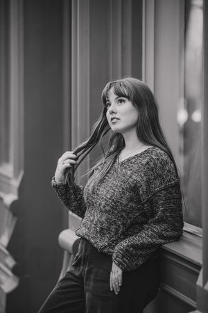 Black and white portrait series showcasing dramatic poses against a window backdrop.