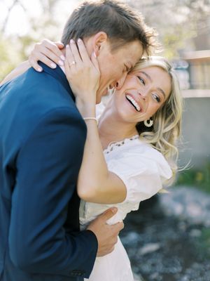 Couple laughing together in formal wear during an intimate moment.