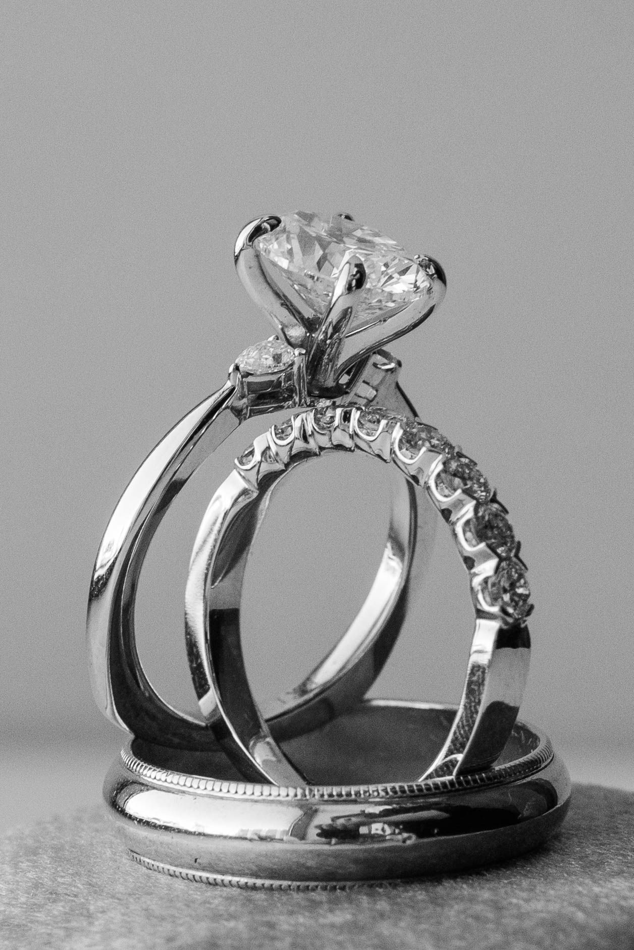 Close-up of elegant diamond wedding rings in black and white.