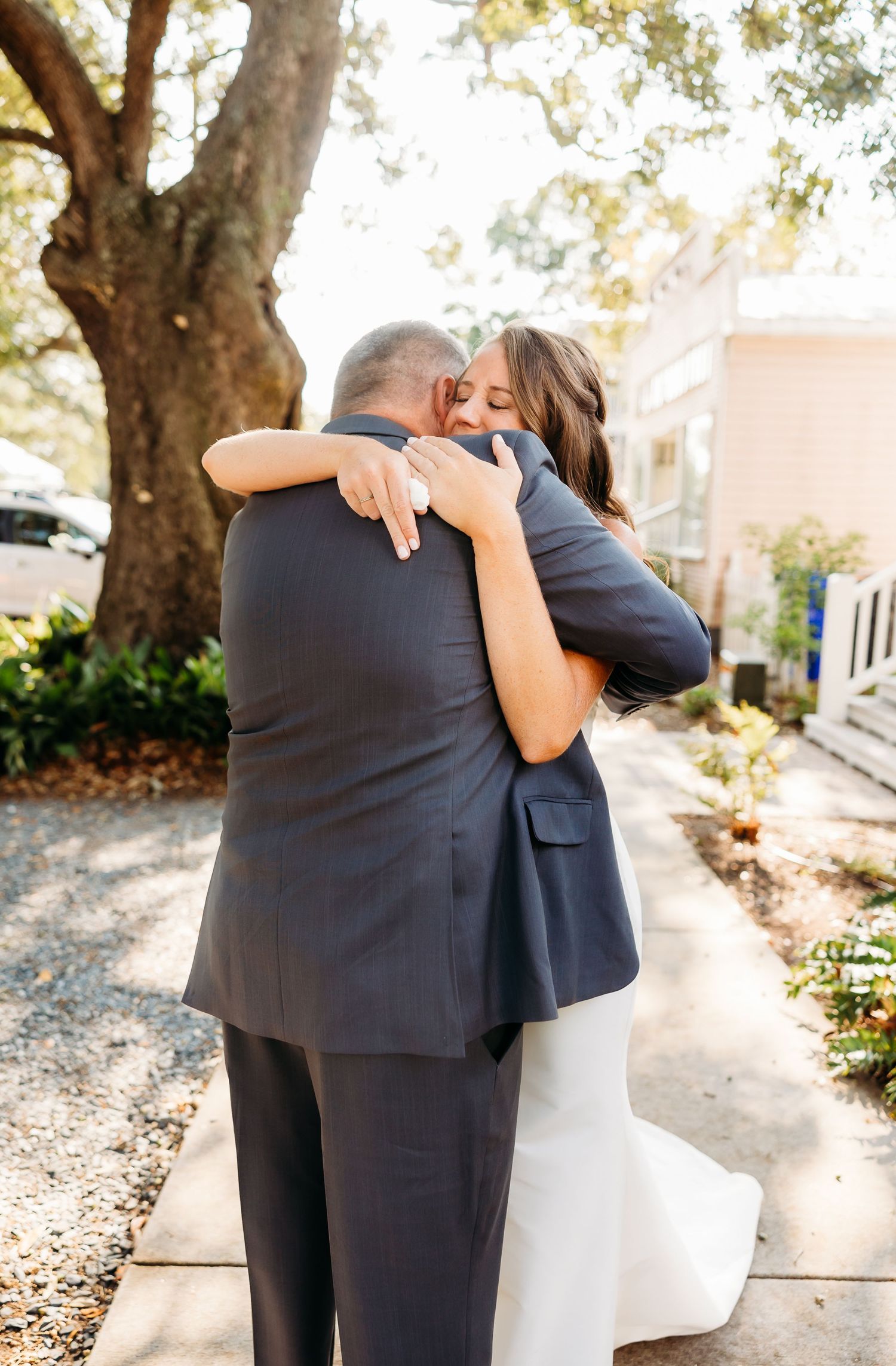 A couple shares an intimate embrace during their wedding day, captured in a series of romantic outdoor photos.