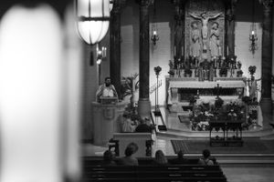 Interior view of a church sanctuary with ornate stained glass windows and religious symbols.