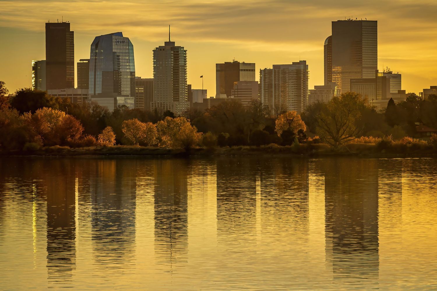 Reflection shot of Downtown Denver at sunrise by Denver Drone, Hospitality, Travel & Tourism photographer Captain Colorado Photography.