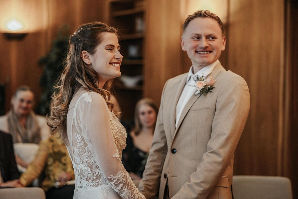 A couple shares joyful laughter during their wedding celebration.