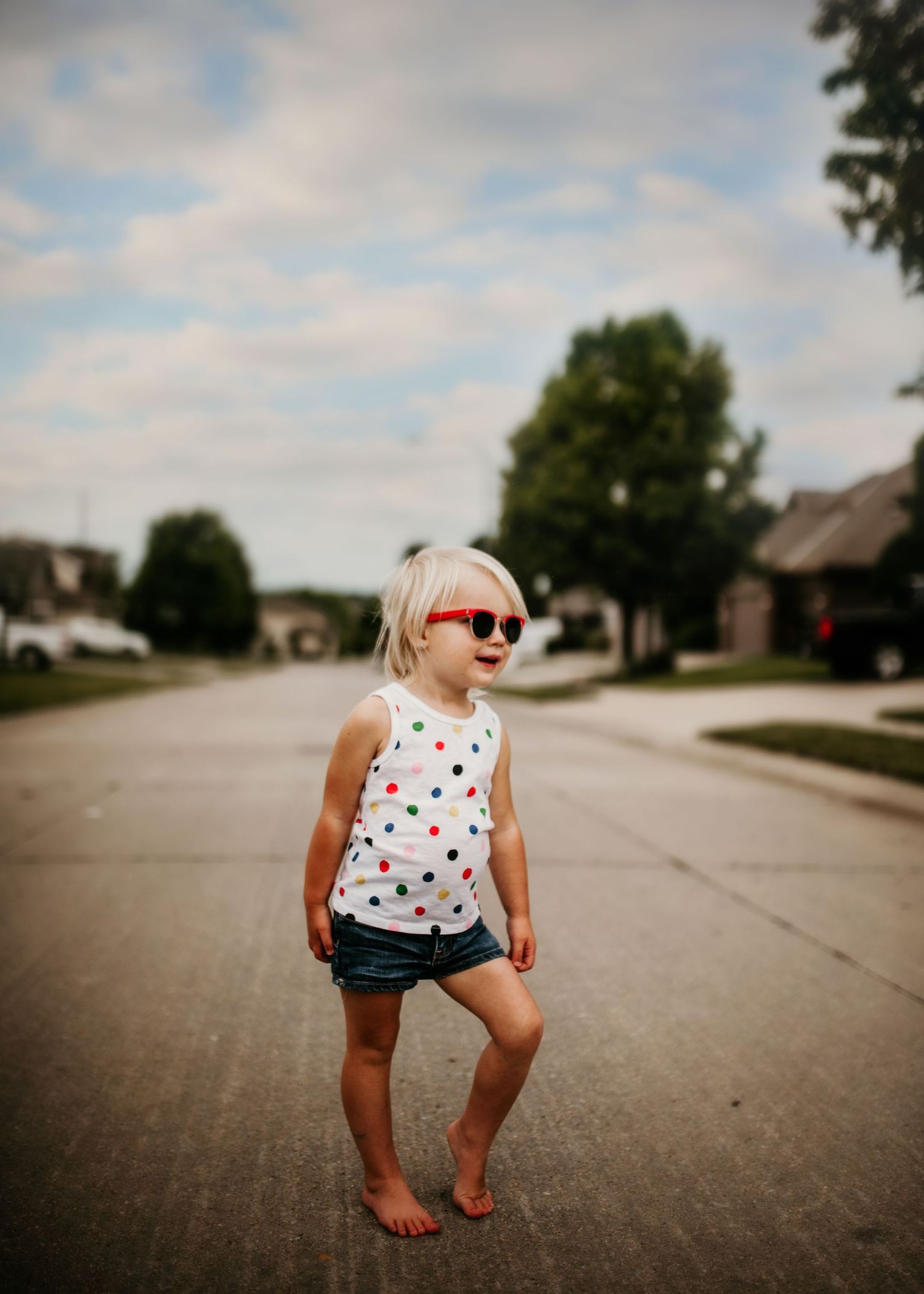 Little girl on neighborhood street during summer
