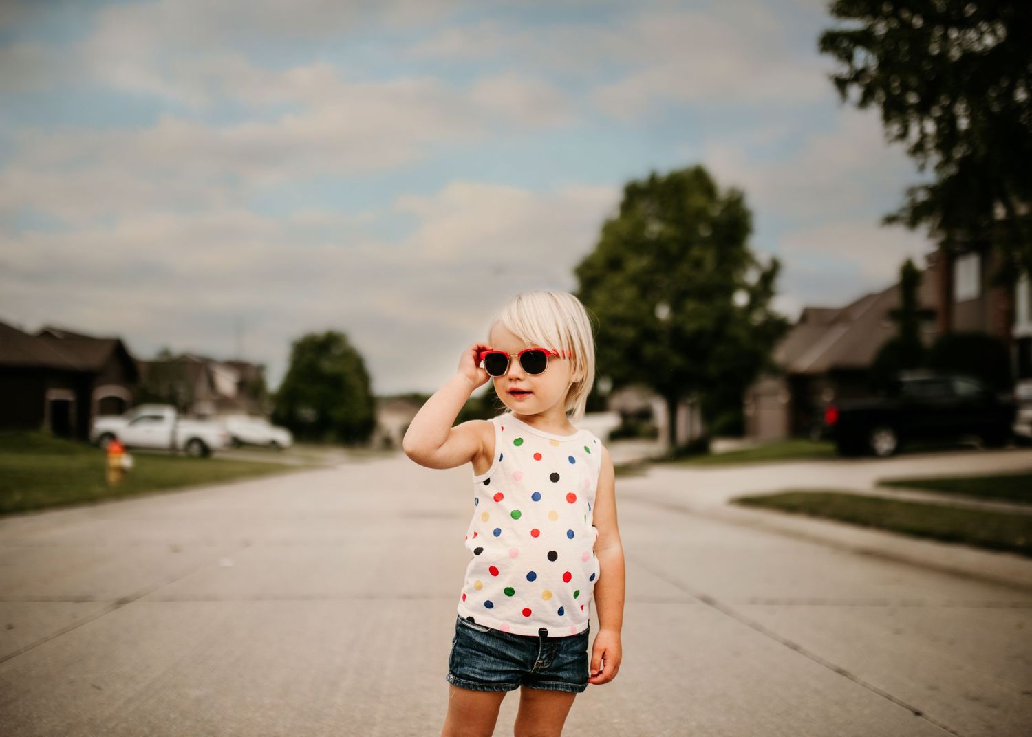 Cool image of kid during the summer wearing red sunglasses