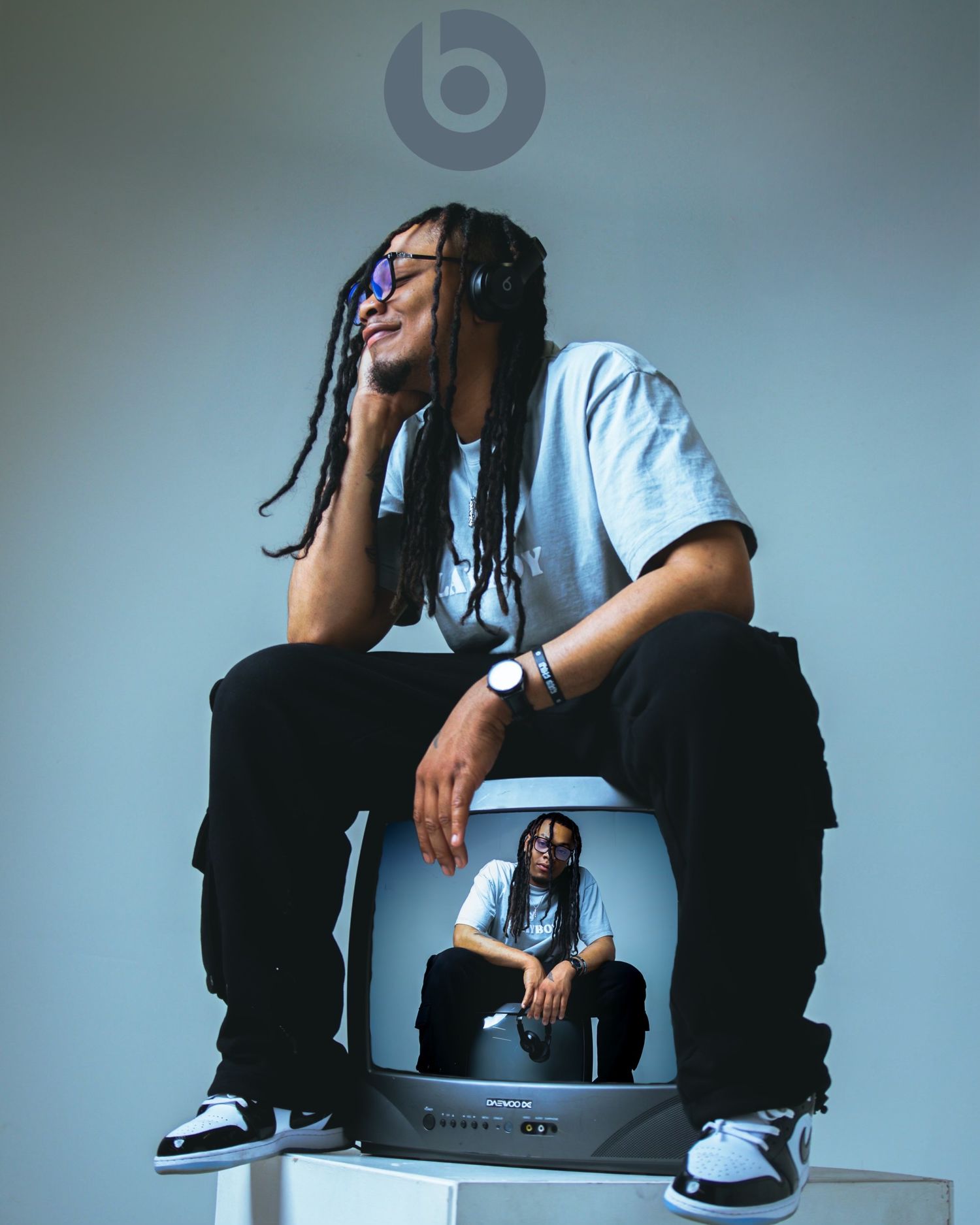 Artistic portrait series showing a person in casual attire sitting against a plain backdrop.