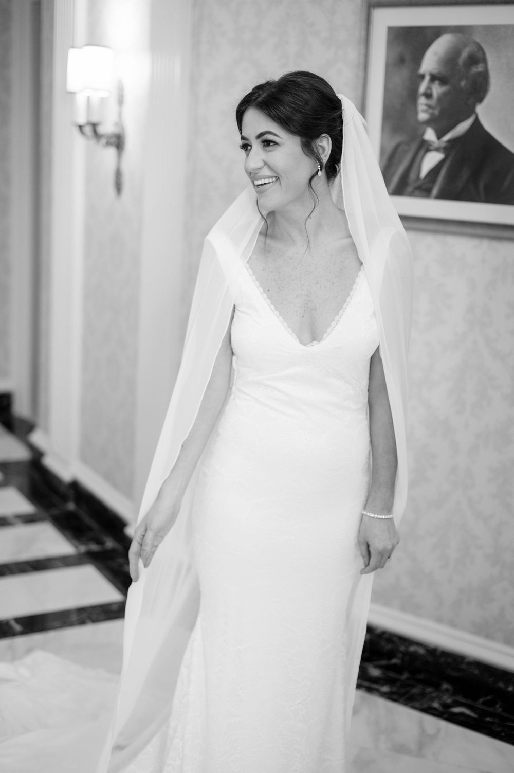 Elegant bridal portrait showing flowing white wedding dress and veil.