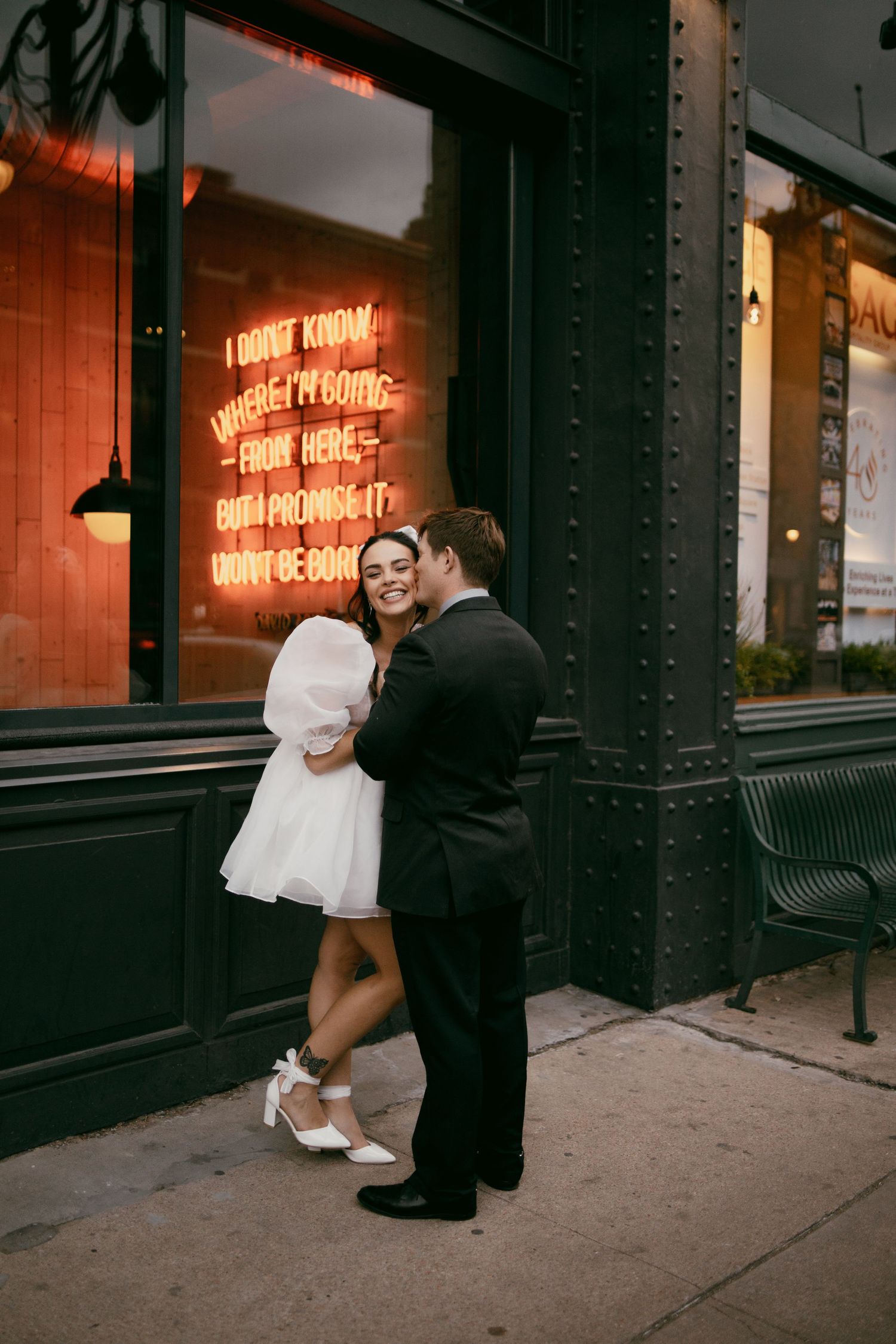elopement couple in downtown Denver with cute while puff dress and black suit