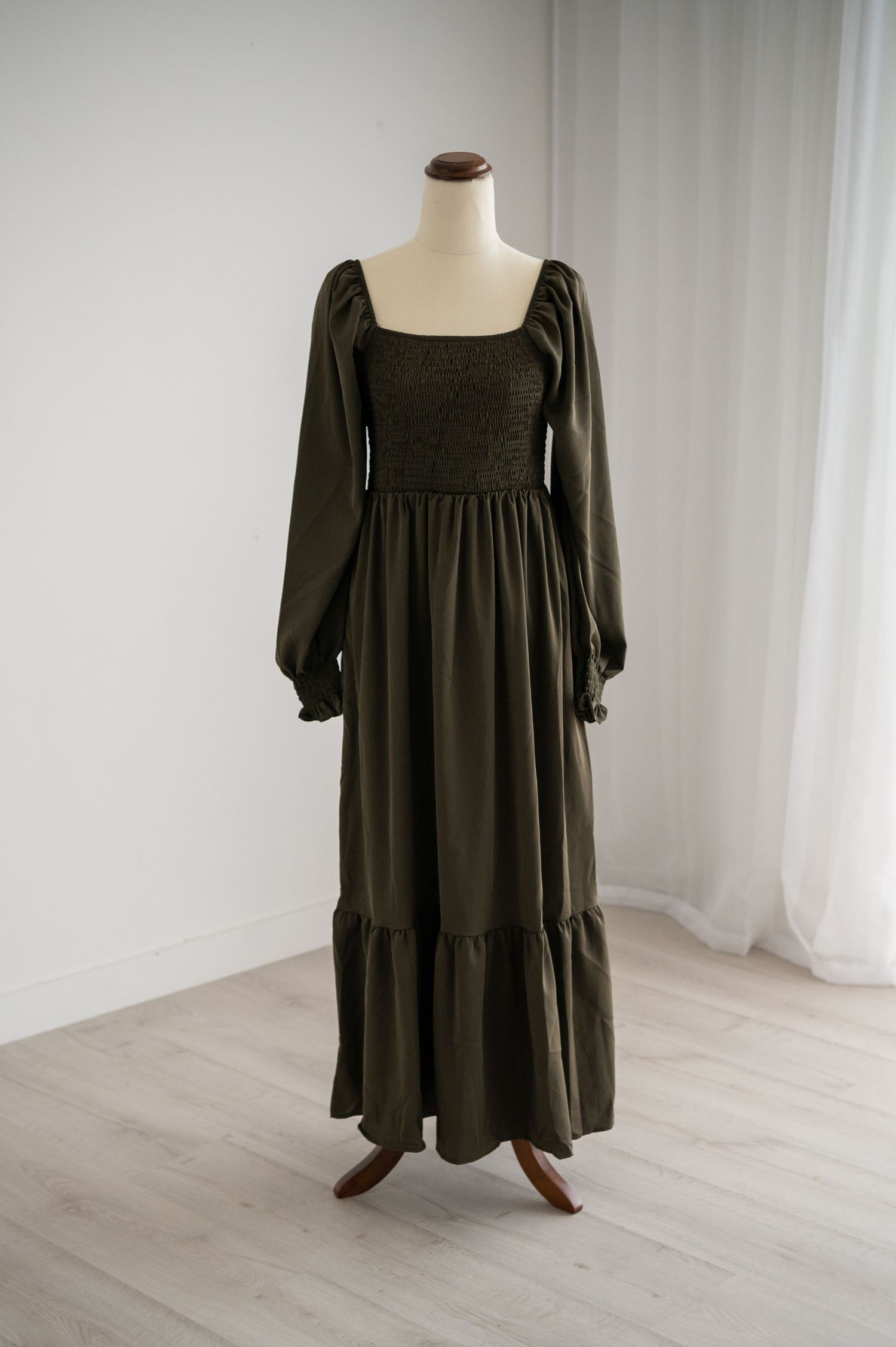 Olive green maxi dress with square neckline and balloon sleeves displayed on mannequin.