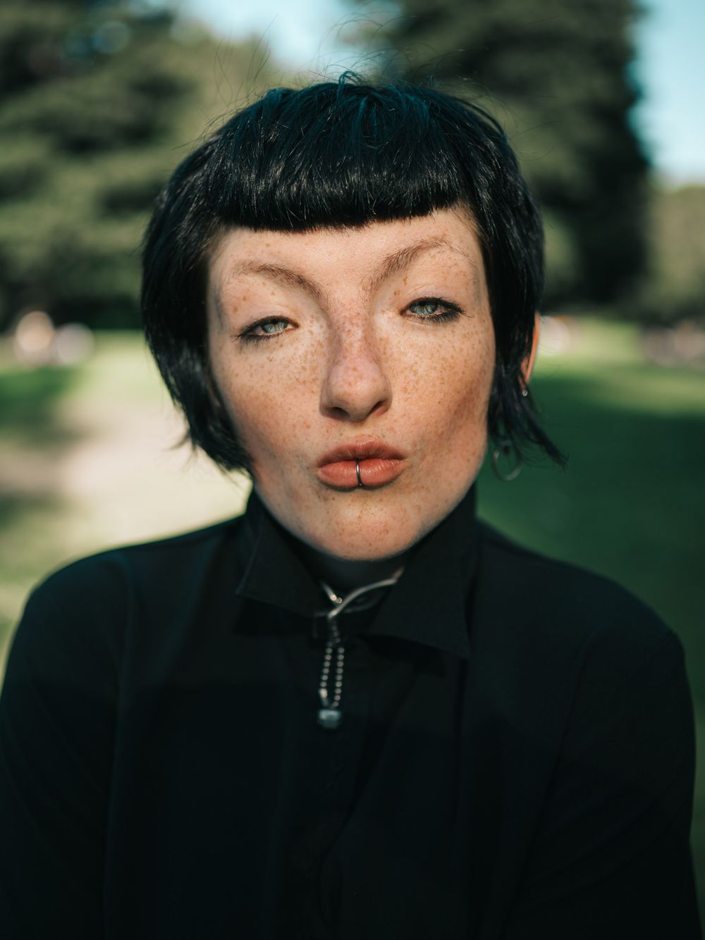 A series of close-up portrait shots showing dark hair and bangs against a blurred outdoor background.
