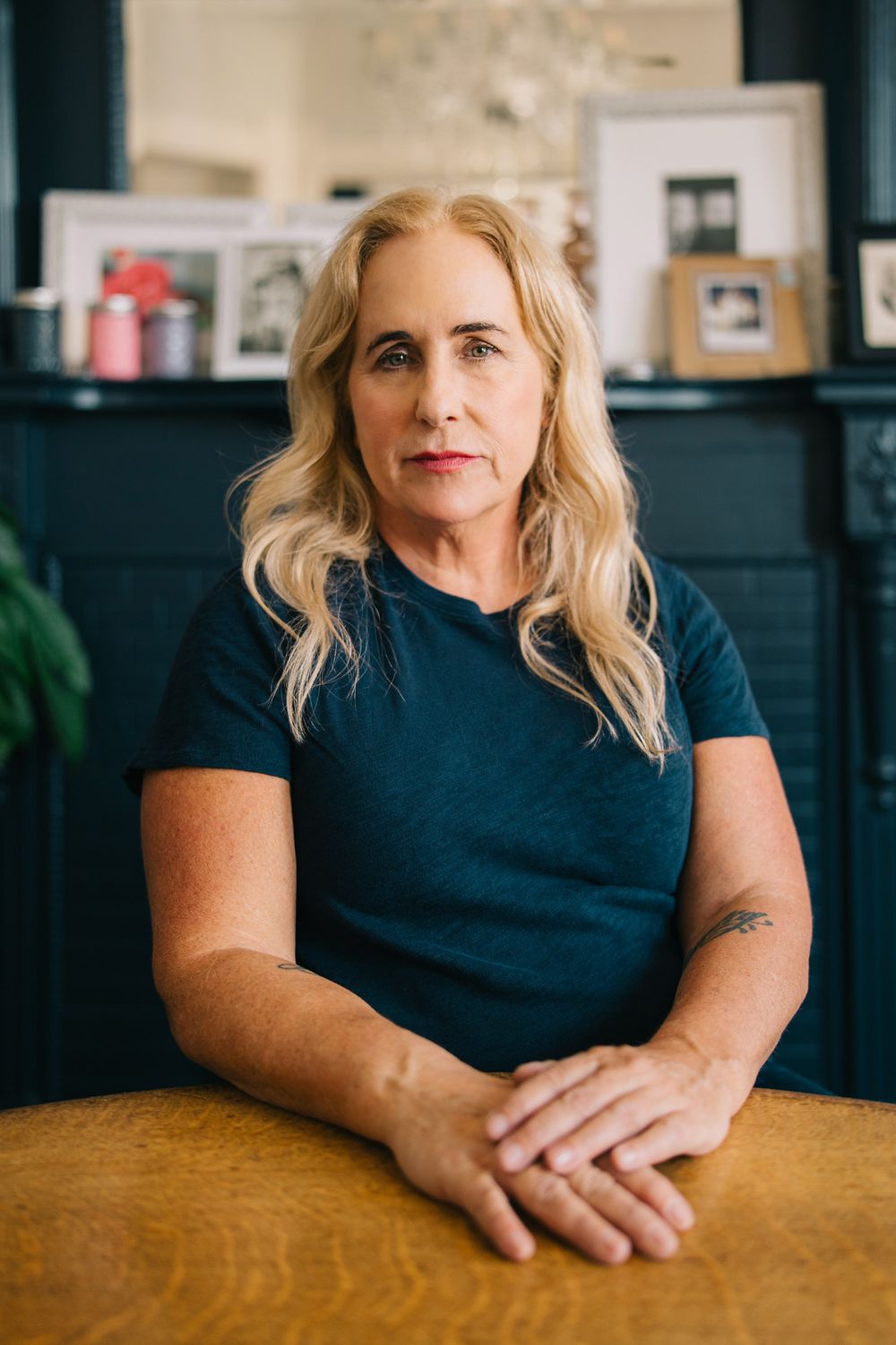 A person in a navy blue shirt sits at a wooden table in a sequence of similar poses.